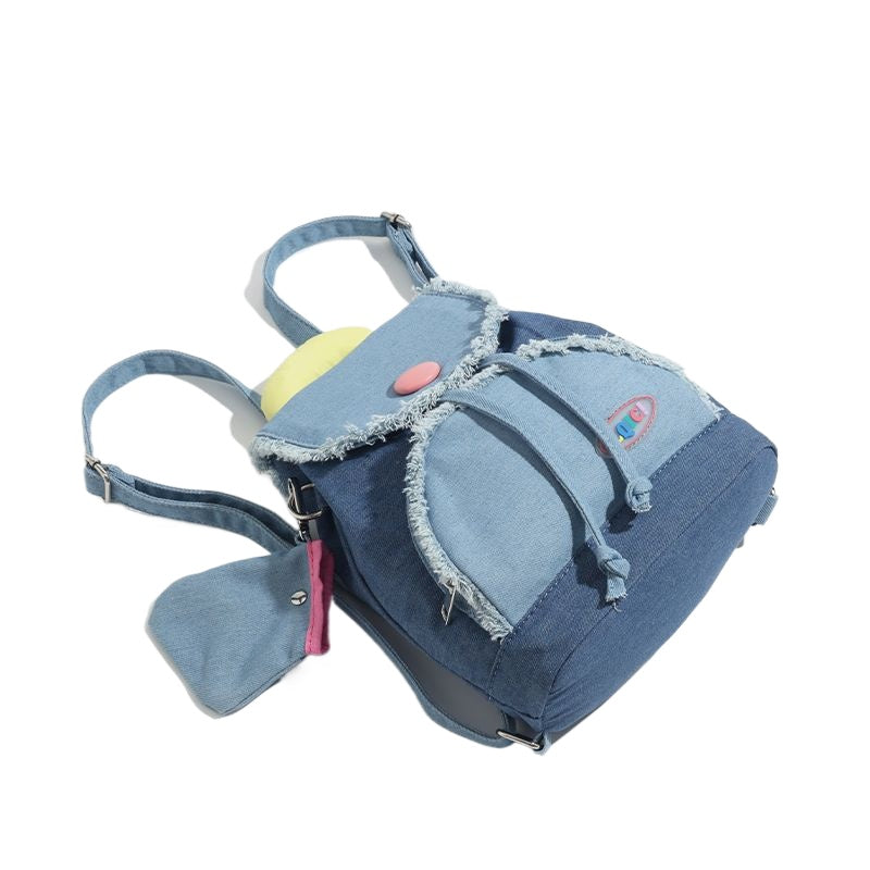 กระเป๋าเป้สะพายหลังทรงโดนัทพู่ผ้าเดนิมตัดกัน